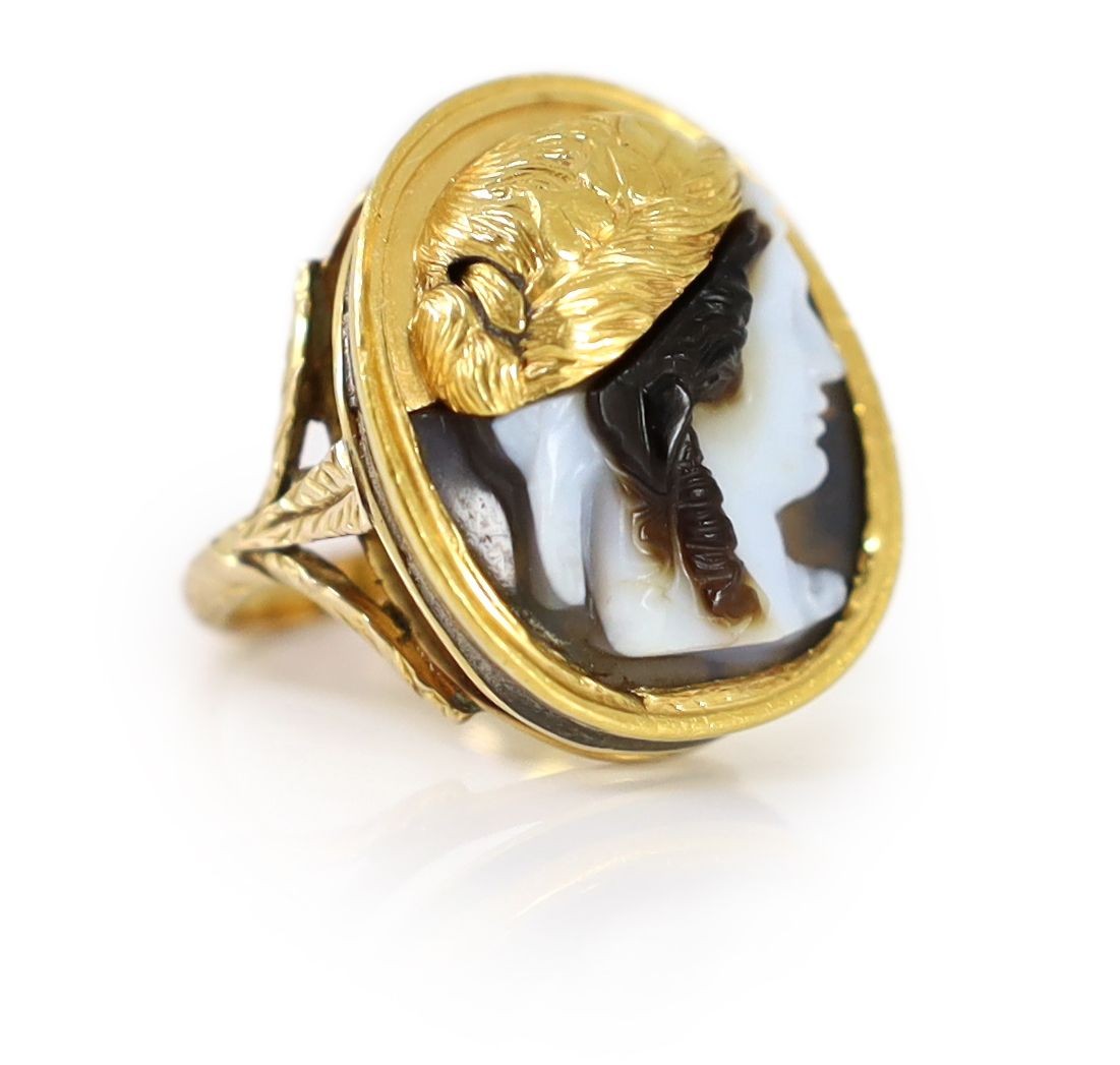 An antique gold mounted sardonyx cameo, possibly carved with the head of a Alexander The Great to sinister, now in later 9ct gold ring mount